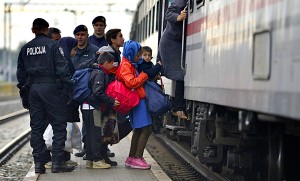 October 5, 2015; Tovarnik in Croatia. Croatian police assist refugees get into train which will go to Hungary.